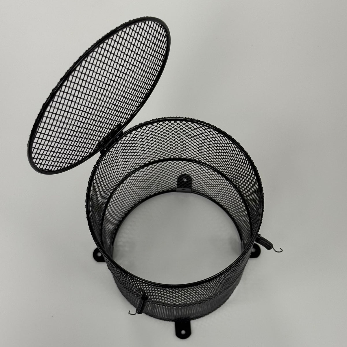 Heat lamp safety cage with the hinged bottom access door open for bulb changes